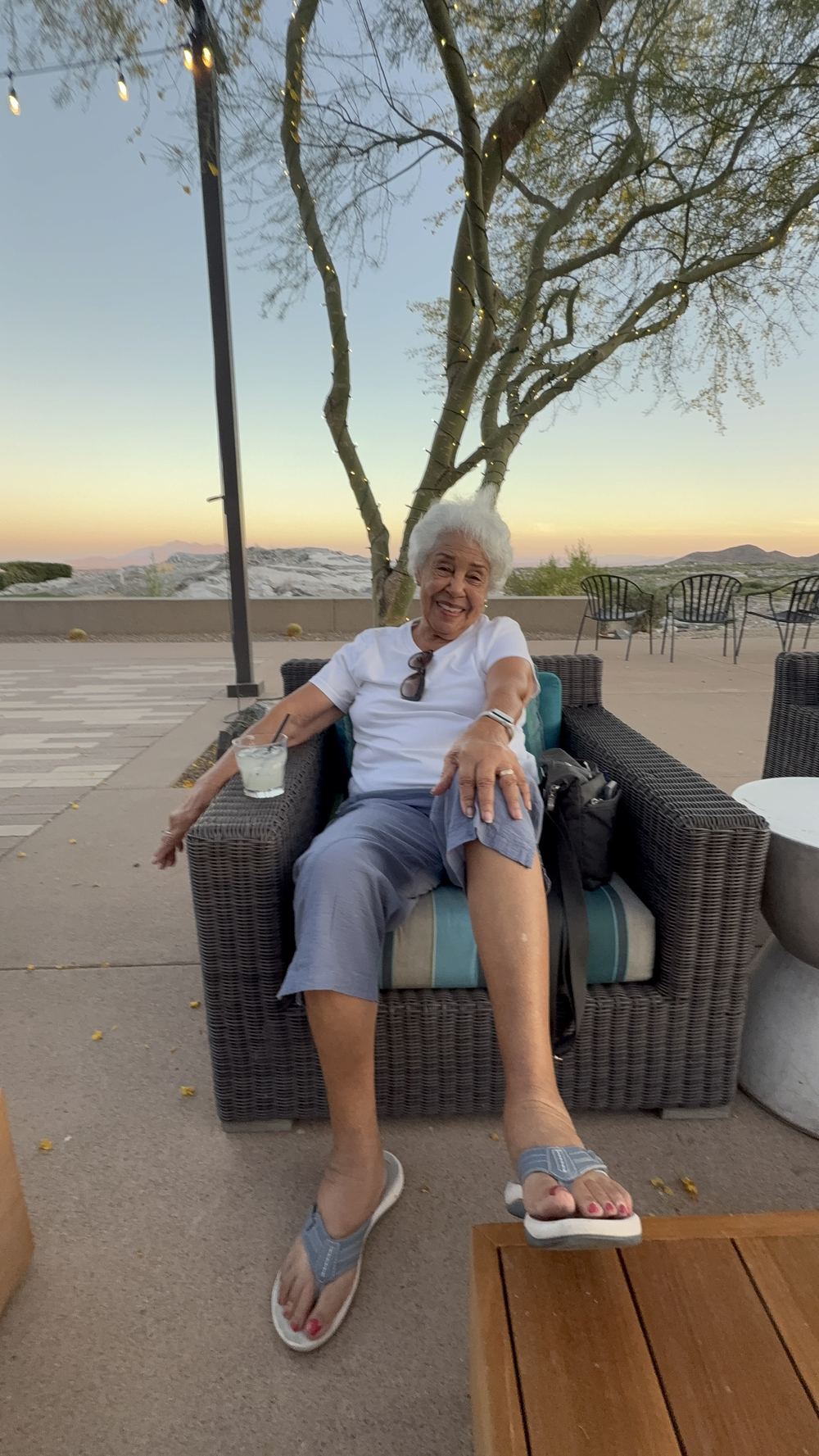 Grandma relaxing on patio at sunset