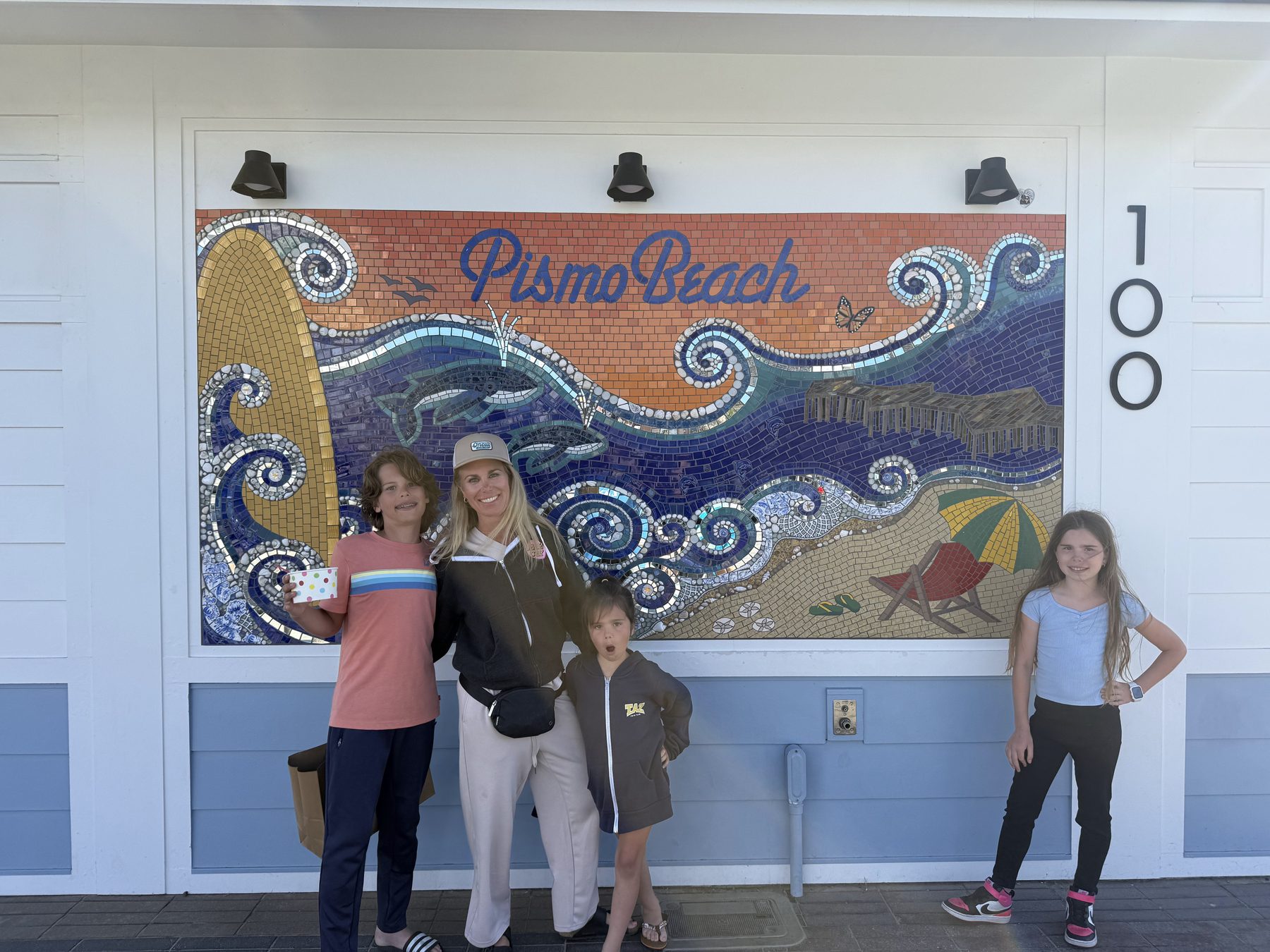 Dana and kids in front of the Pismo Beach mosaic tile mural at 100 Pomeroy