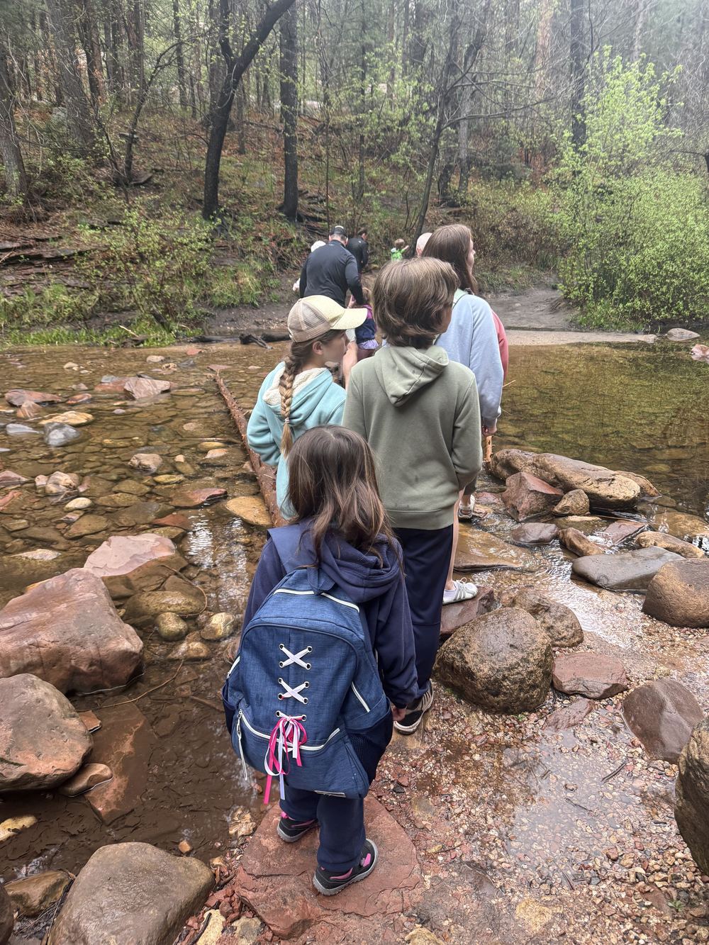 Family crossing the stream
