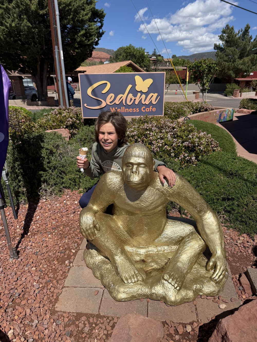 Kid with gold gorilla statue