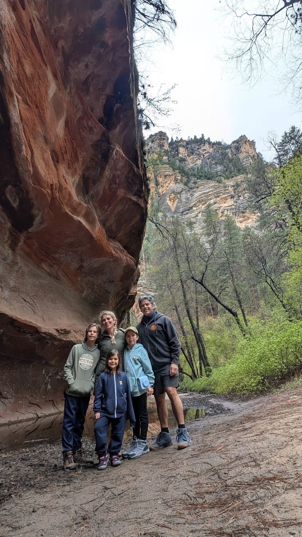Leone family under the red rock canyon wall — West Fork