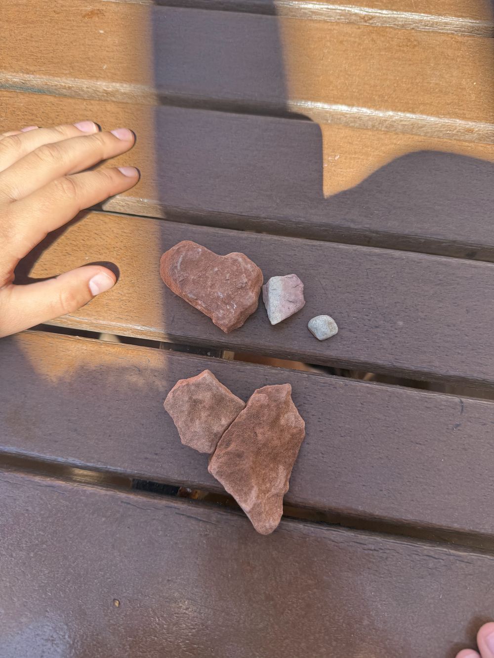 Red rocks collected on a bench
