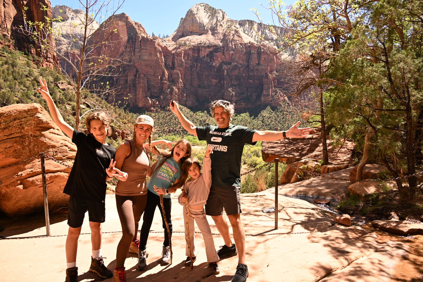 Tiny solo climber on massive Zion canyon wall