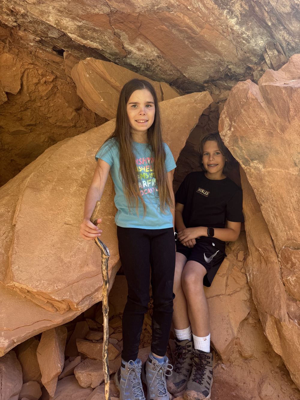Two kids in a rock crevice