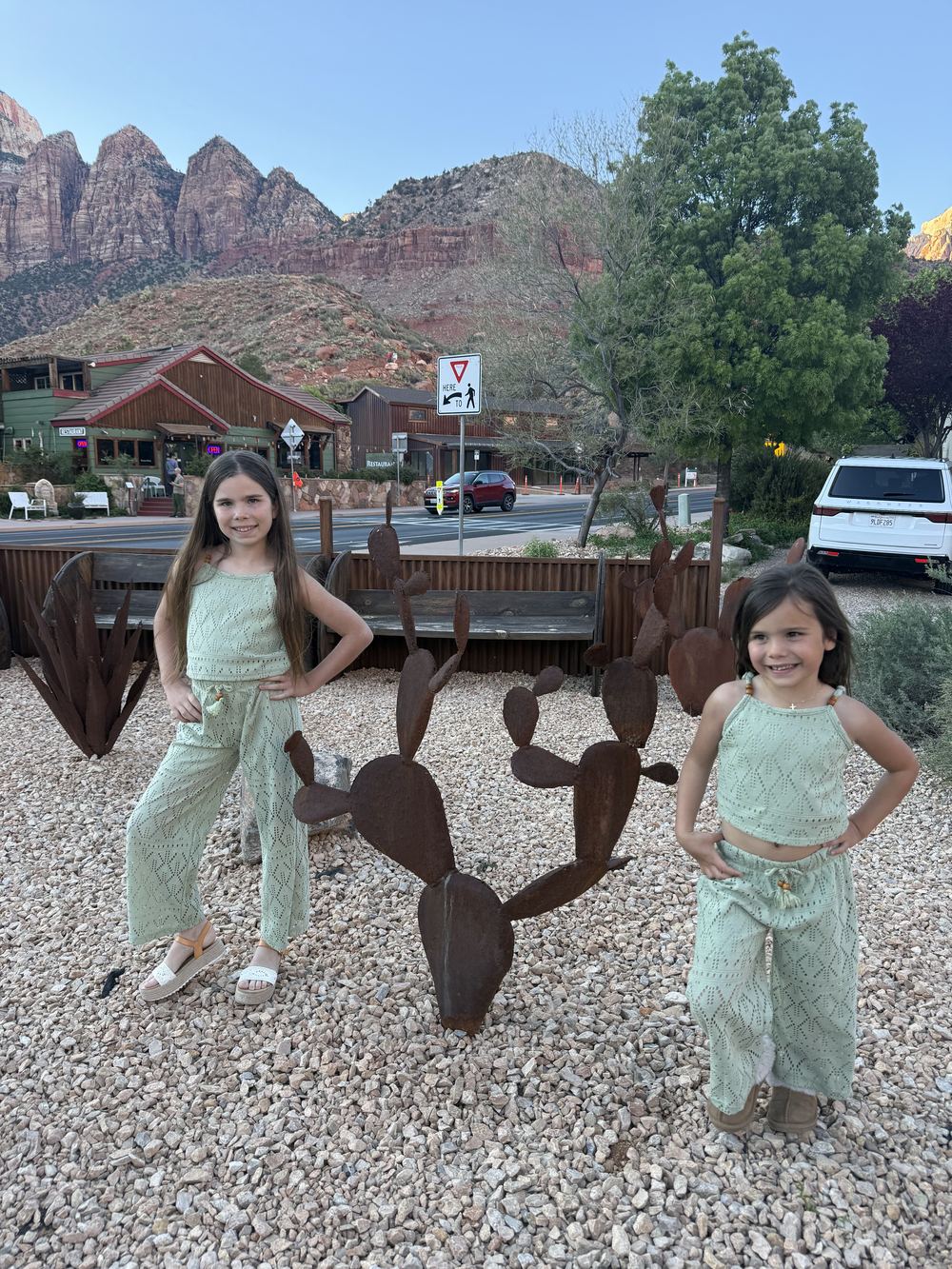 Girls in matching outfits by cactus sculpture — Springdale