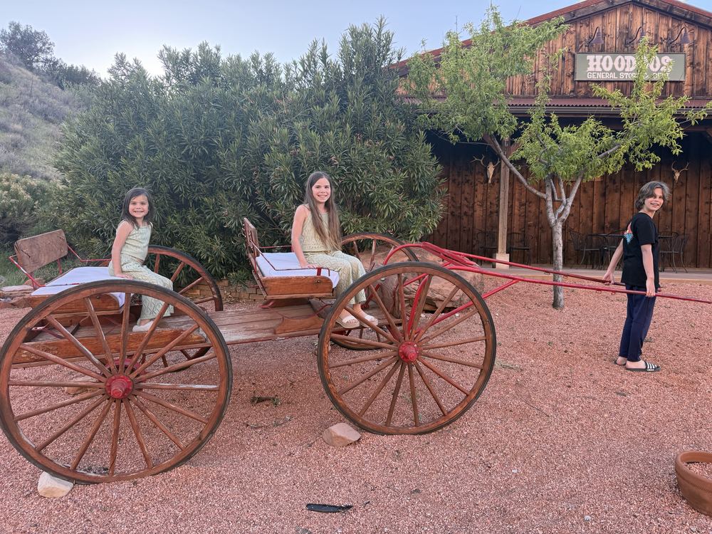 Kids in old wagon outside Hoodoos General Store